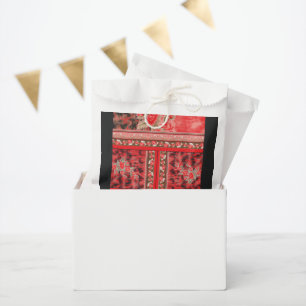 a red and green floral design on a black backgroun favour bags