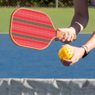 a red and green striped background pickleball paddle