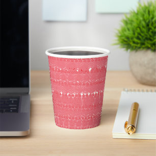 A red and pink geometric pattern featuring interlo paper cups