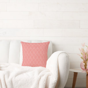 a red and white background with a pattern cushion