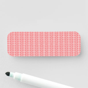a red and white background with a pattern name tag