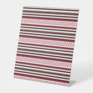 a red and white striped pattern pedestal sign