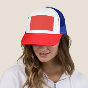 a red background with a white border trucker hat