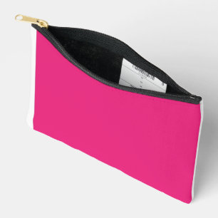 A red rose with vibrant petals surrounded by delic accessory pouch
