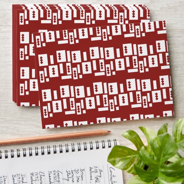 A red rug with a textured pattern is spread out on envelope (Stacked)