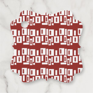 A red rug with a textured pattern is spread out on favour tags