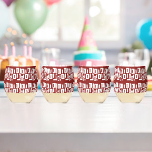 A red rug with a textured pattern is spread out on stemless wine glass