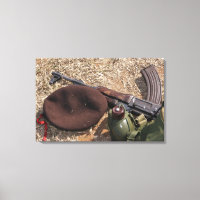 A rifle, military cover and canteen