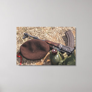 A rifle, military cover and canteen canvas print