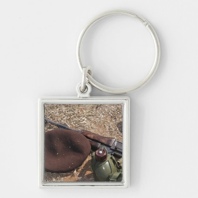 A rifle, military cover and canteen key ring (Front)