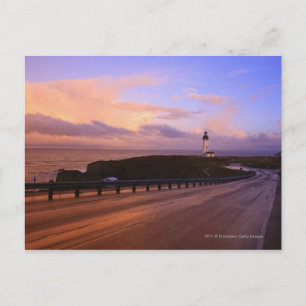 A Road & A Lighthouse Along The Coast At Sunset Postcard