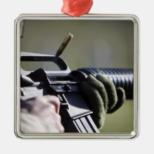 A round flies from the chamber of an M-16A2 Metal Tree Decoration