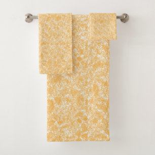 A round rug with a vibrant blend of yellow and ora bath towel set