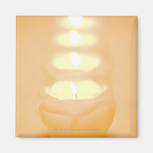 A row of lit candles magnet