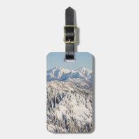 A Scenic View of Snowy Mountains and Trees.