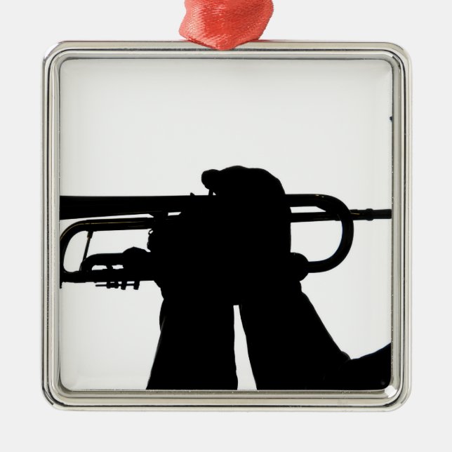 A service member plays a tune metal tree decoration (Front)