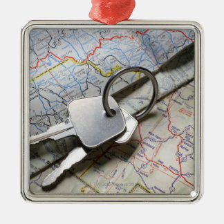 A set of car keys on a pile of road maps. metal tree decoration