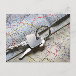 A set of car keys on a pile of road maps. postcard