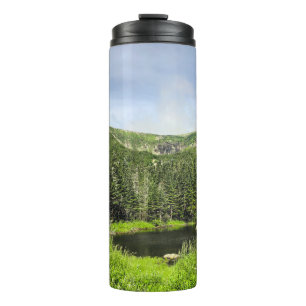 A small pond in the valley of the mountains in the thermal tumbler