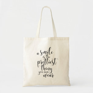 A smile is the prettiest thing you can wear tote bag