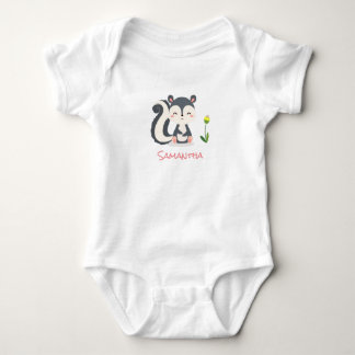 A Smiling Baby Skunk With a Yellow Flower Bodysuit