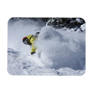 A snowboarder rips untracked powder turns in 2 magnet