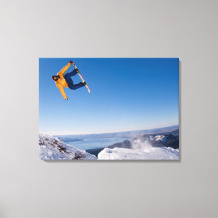 A snowboarder spins off a jump in Argentina Canvas Print