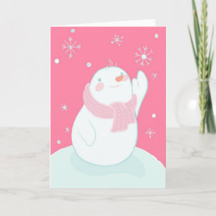 A snowman reaching for a falling snowflake holiday card