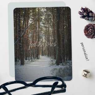 A snowy trail in a winter pine forest holiday card