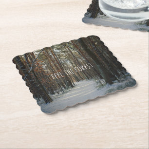 A snowy trail in a winter pine forest paper coaster