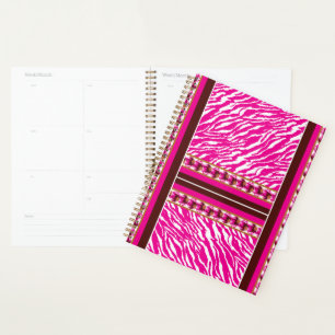 A soft pink and white flower motif gracefully pres planner