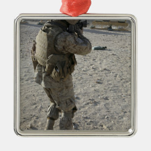 A soldier engages his target on a shooting rang metal tree decoration