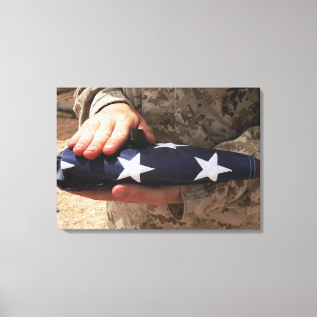 A soldier holds the United States flag Canvas Print (Front)