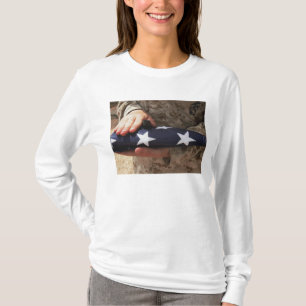 A soldier holds the United States flag T-Shirt