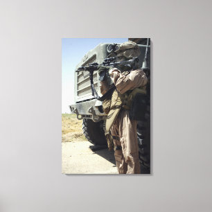 A soldier provides security for Marines Canvas Print