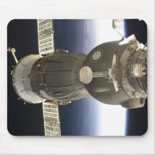 A Soyuz spacecraft backdropped by Earth Mouse Pad