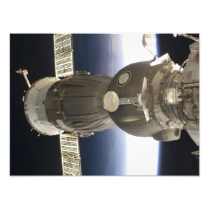 A Soyuz spacecraft backdropped by Earth Photo Print