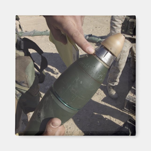 A squad leader points to a delay setting magnet (Front)