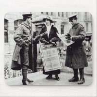 A Suffragette selling newspapers to two