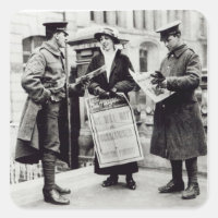 A Suffragette selling newspapers to two