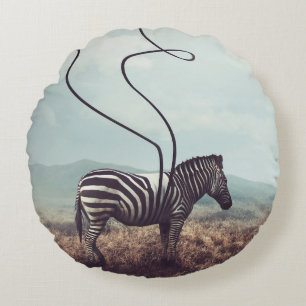 A surreal image of a zebra and two of its black st round cushion