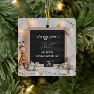 A sweetly sitting giraffe  pregnancy announcement  ceramic ornament