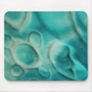 A swirling pattern in teal and light beige mouse pad