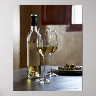 A table with bottle and two glasses of Spanish Poster