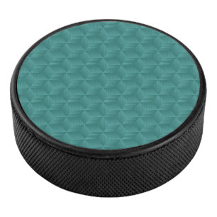 A teal geometric pattern adorns the top hockey puck