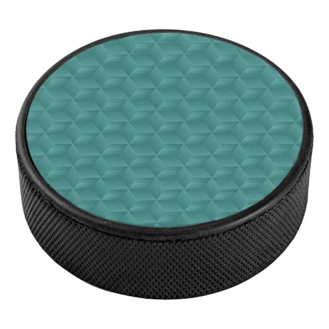 A teal geometric pattern adorns the top  hockey puck (3/4)