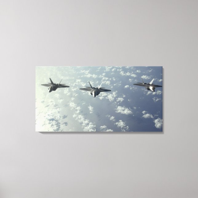 A three-ship formation of F-22 Raptors Canvas Print (Front)