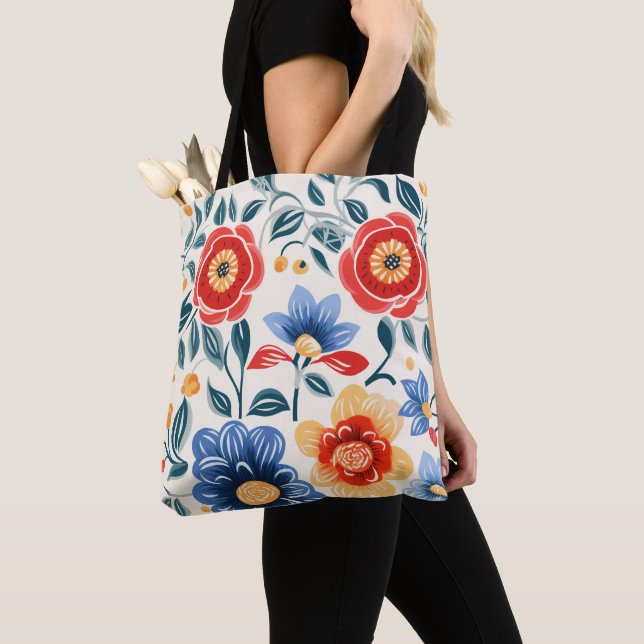 A tote bag with black handles features a colourful (Close Up)