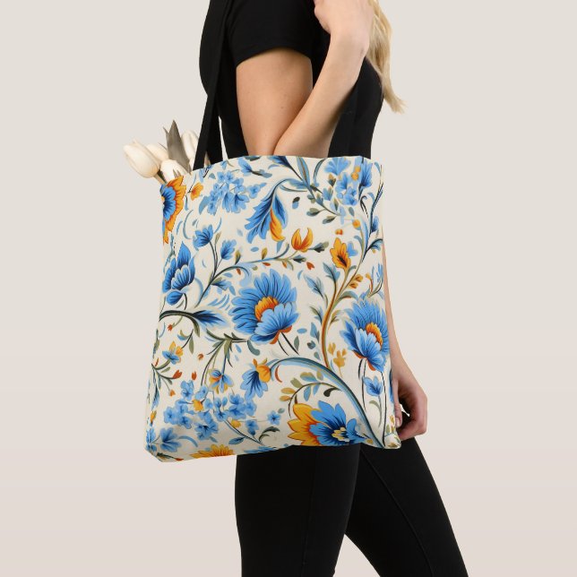 A tote bag with black handles featuring a vibrant  (Close Up)