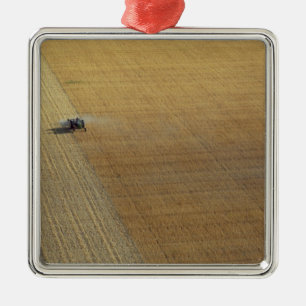 A tractor harvesting metal tree decoration